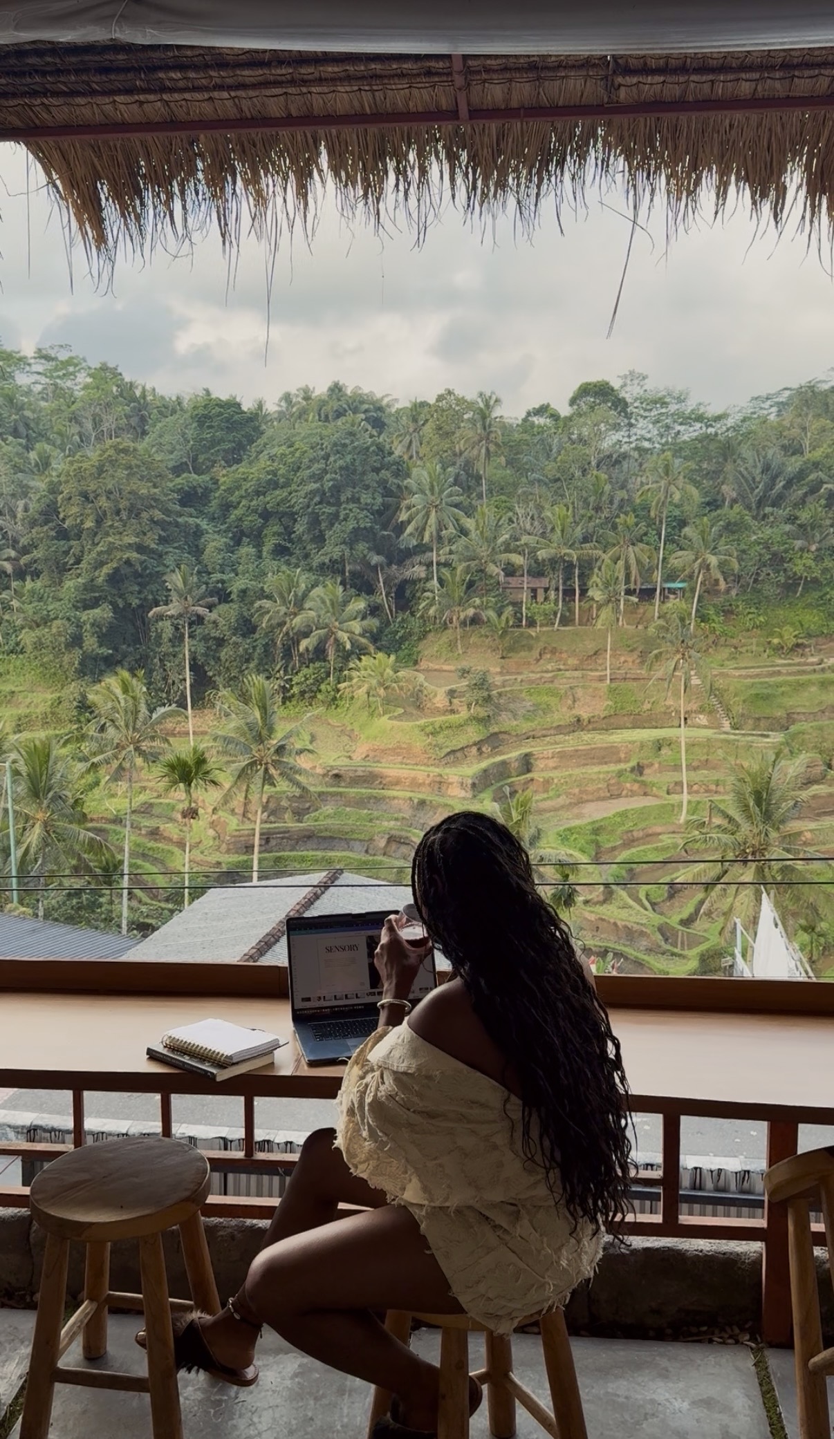 India working on her laptop above the rice terraces in Bali